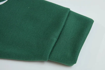 Close up of green spider web zipper hoodie for women sleeve cuff ribbed knit fabric and quality stitching