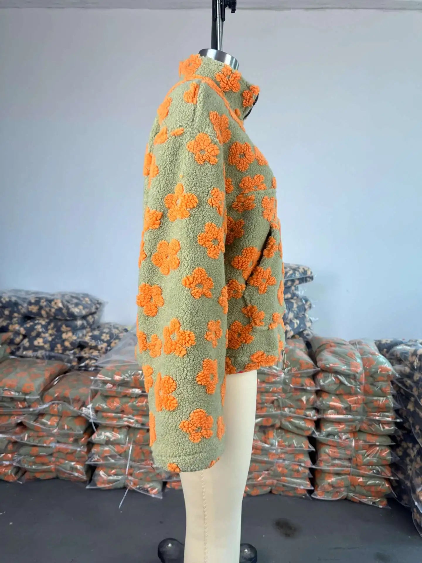 Cozy lambskin coat for women featuring floral patterns in orange and green design