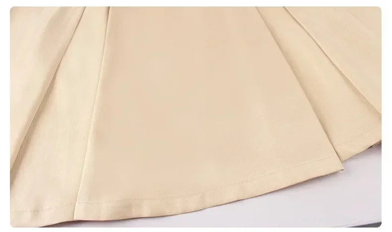 Close-up of M3GAN cosplay costume for kids showing smooth beige fabric and pleated design