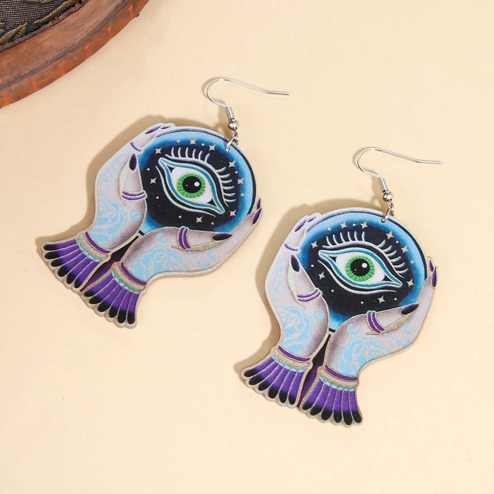 EtherealBe Halloween devil eye earrings featuring colorful hand designs with an eye motif