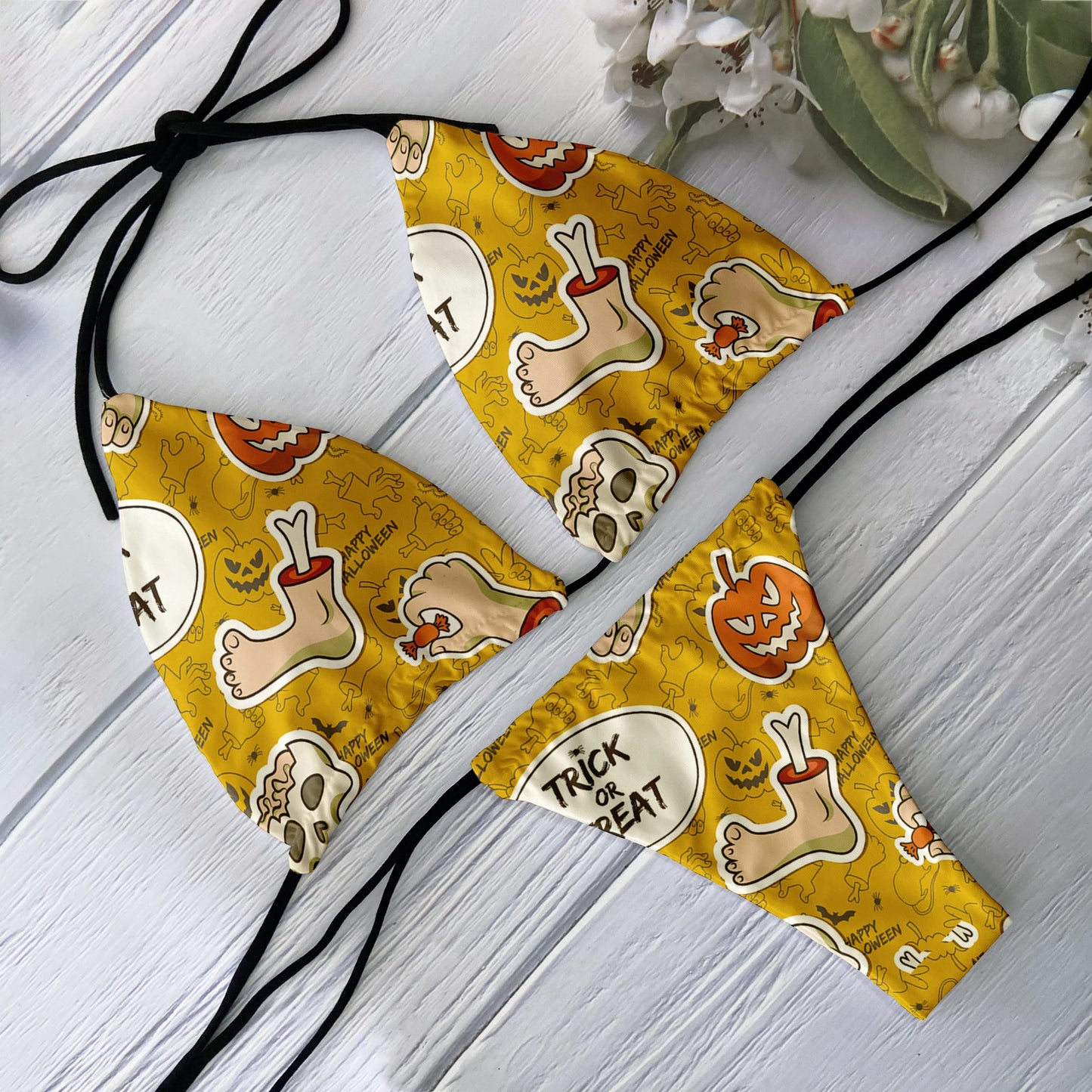 Yellow Halloween skull print bikini set with jack o lanterns severed toe motifs and black tie strings