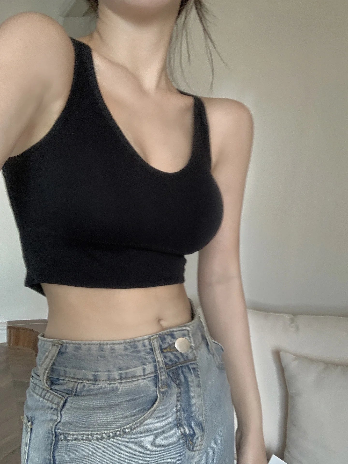 Black push up sports bra sportswear crop top by EtherealBe modeled with high waisted light wash jeans
