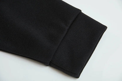 Close up of black spider web zipper hoodie for women showing sleeve cuff ribbing and hem detail on white background