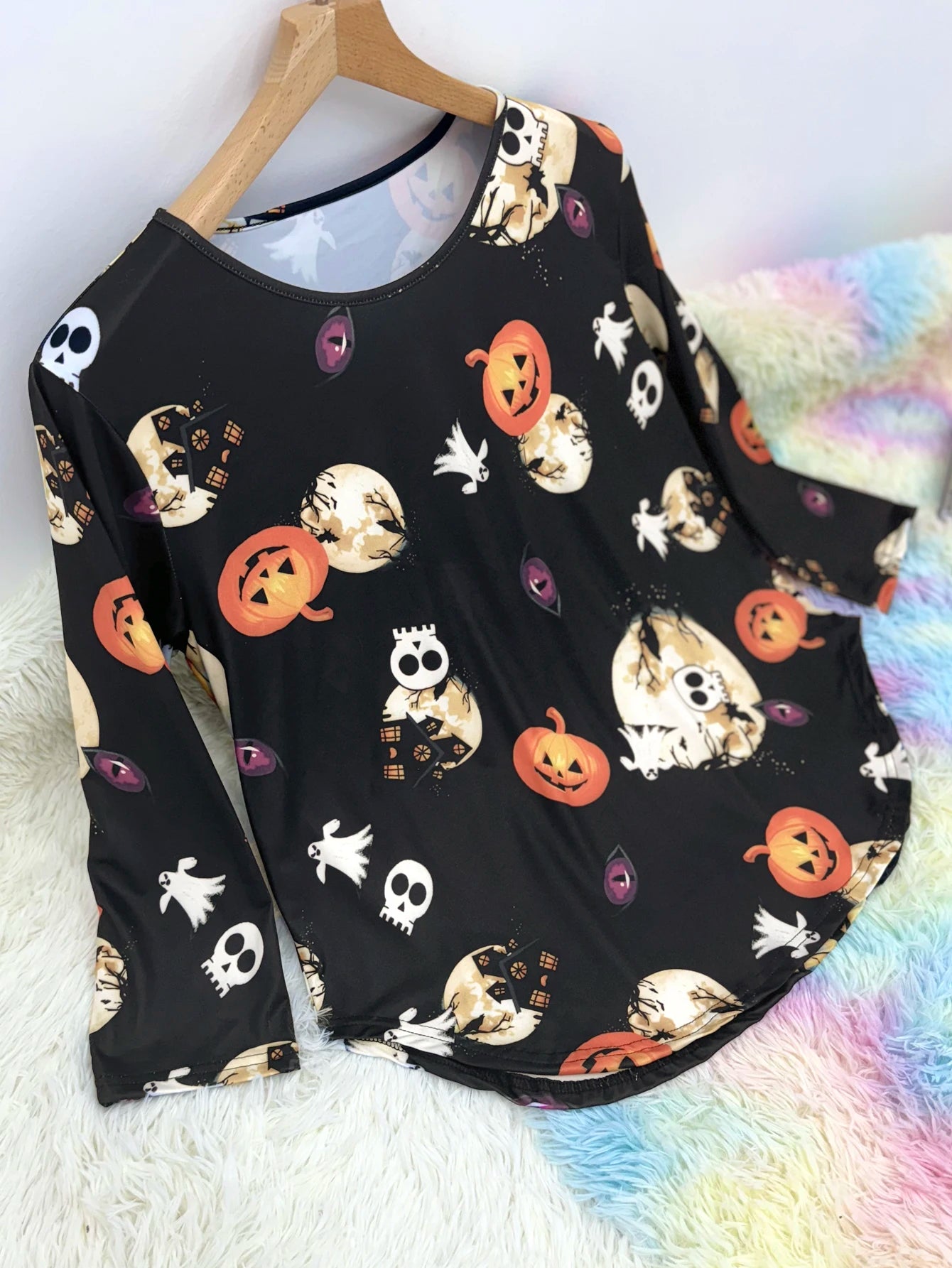 Plus size Halloween pumpkin T-shirt featuring fun skull and pumpkin designs on a black background