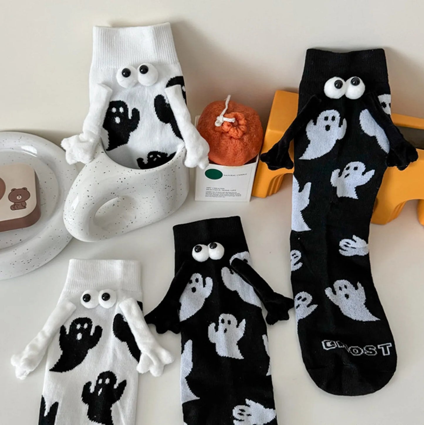 Cute women's Halloween socks featuring ghost designs in black and white for festive wear