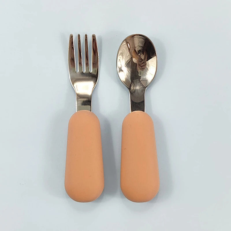 EtherealBe stainless steel baby utensils set featuring soft silicone handles in peach color