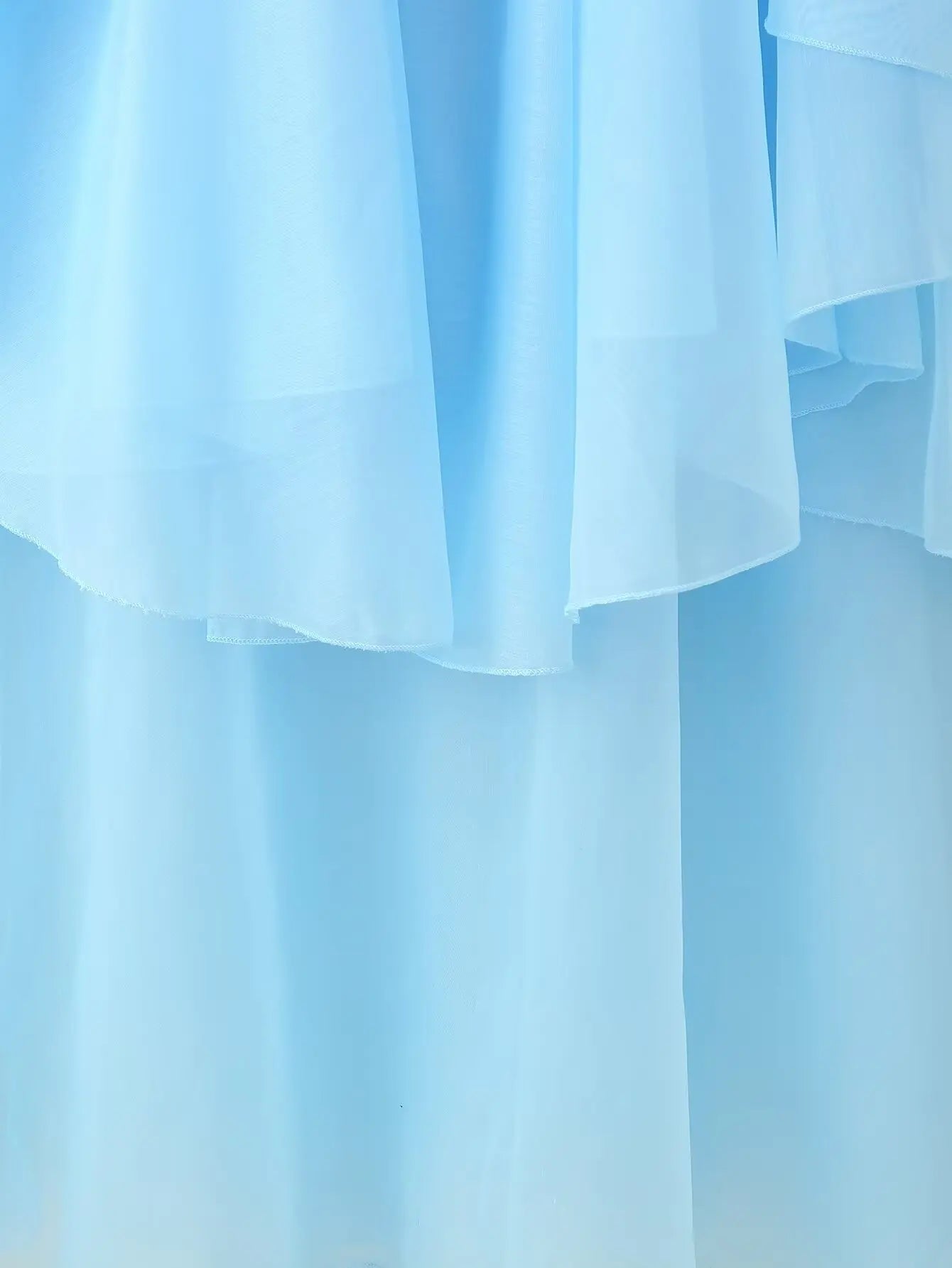EtherealBe elegant layered decorative dress in soft blue with flowing layers for a charming look