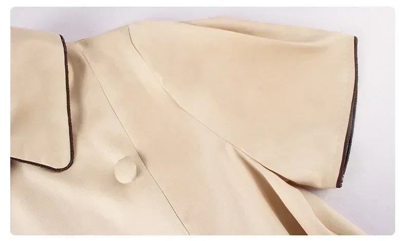 Close-up of M3GAN cosplay costume for kids with smooth beige fabric and contrasting collar details