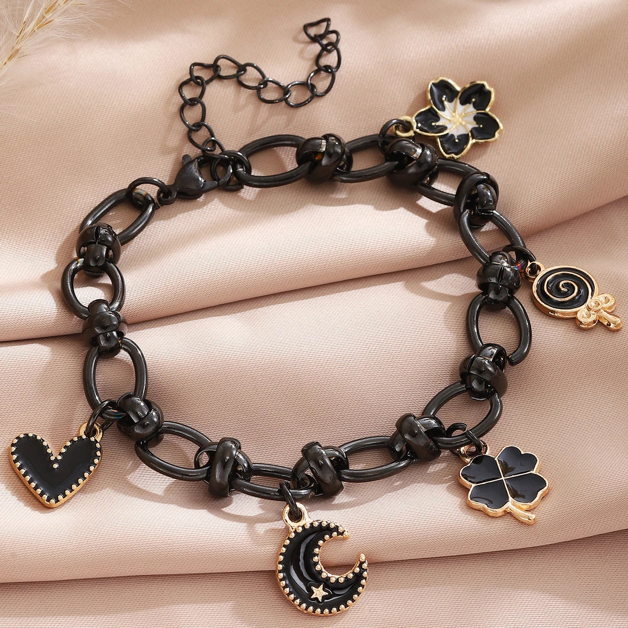 EtherealBe Halloween charm bracelet for women featuring black and gold charms including a crescent moon and heart