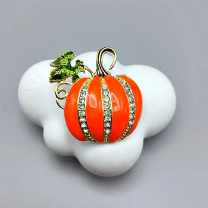EtherealBe Halloween brooch pins featuring a sparkling orange pumpkin design with green leaves