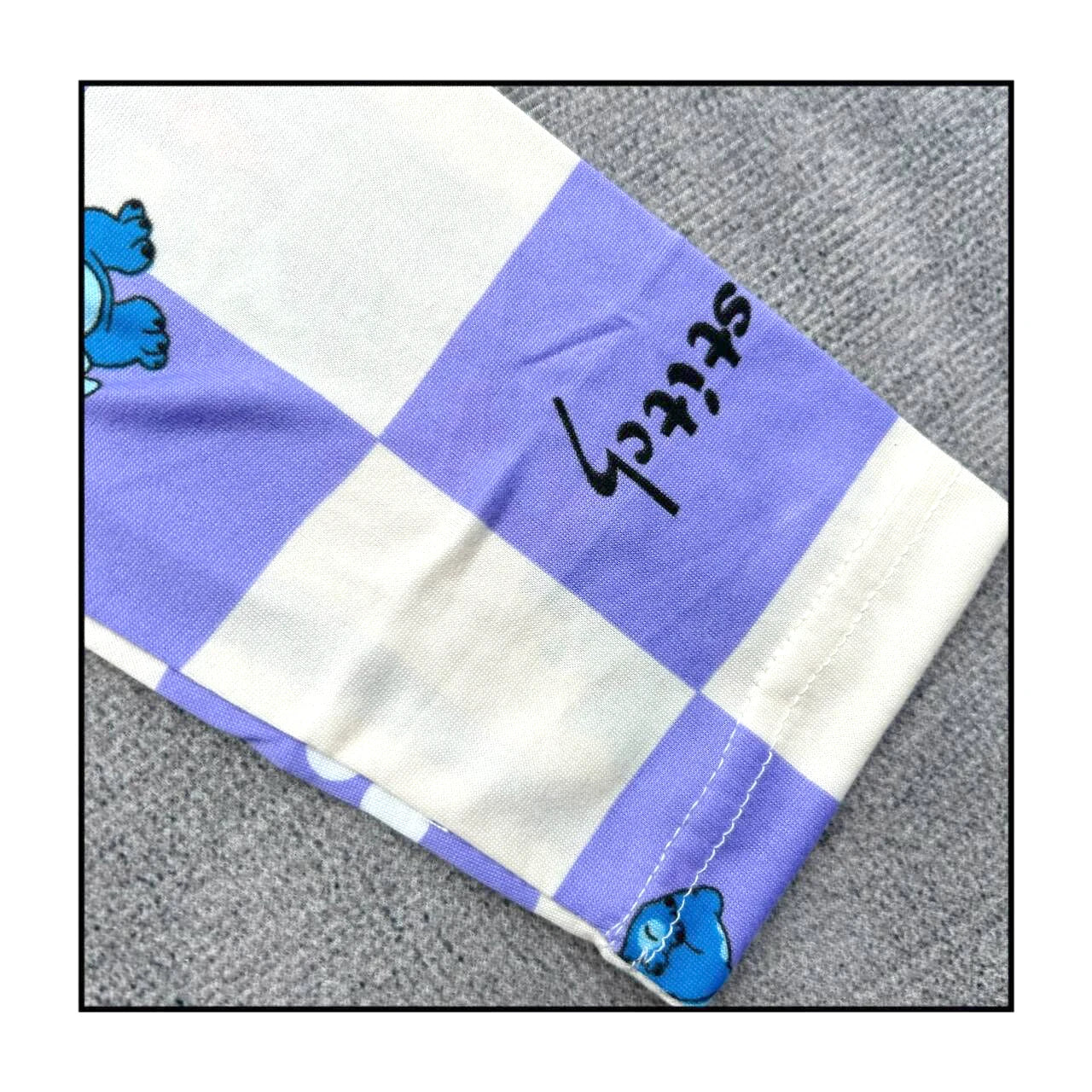 Children's Stitch pajamas set featuring a playful blue and purple checkerboard design