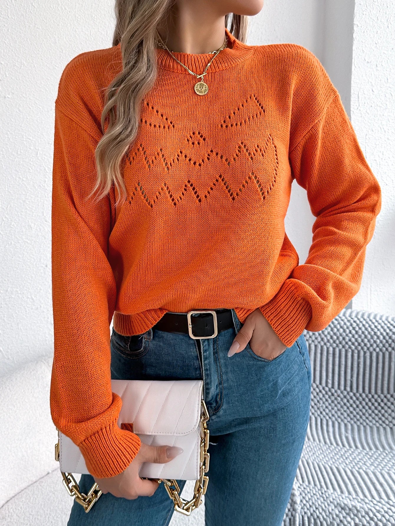 Trendy women's pumpkin sweater in orange with festive jack-o-lantern design, perfect for autumn wear