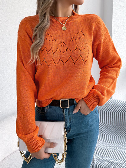 Trendy women's pumpkin sweater in orange with festive jack-o-lantern design, perfect for autumn wear