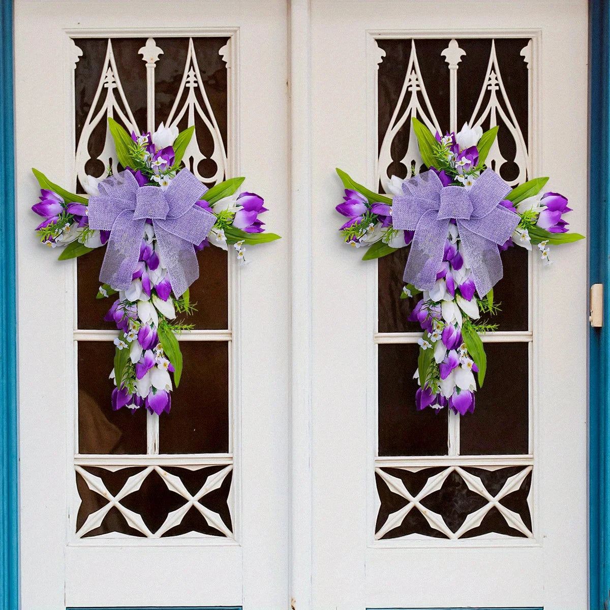 Purple tulip cross wall hanging adorned with a lavender bow and greenery for home decor
