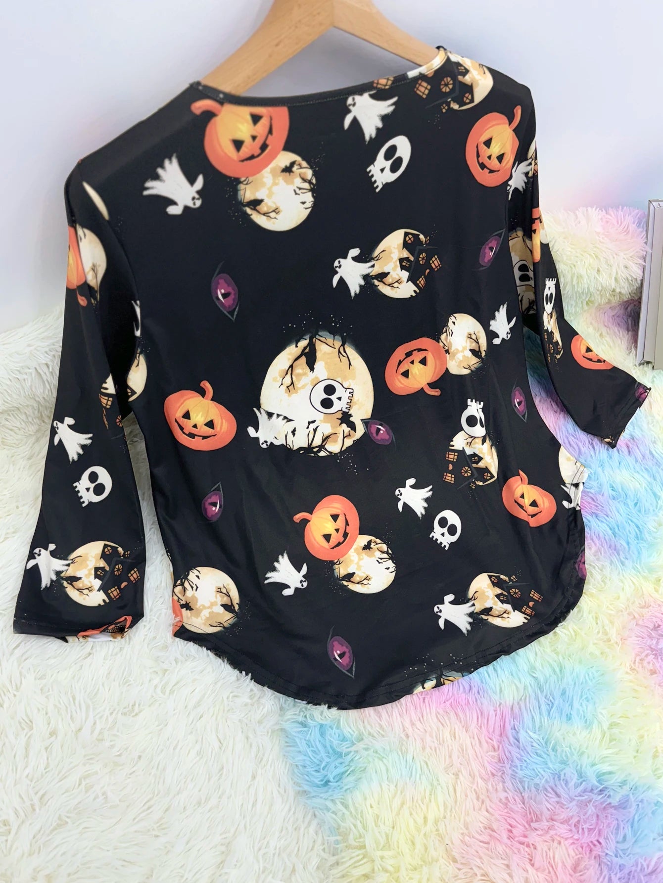 Black plus size Halloween pumpkin T-shirt with colorful spooky patterns and a relaxed fit