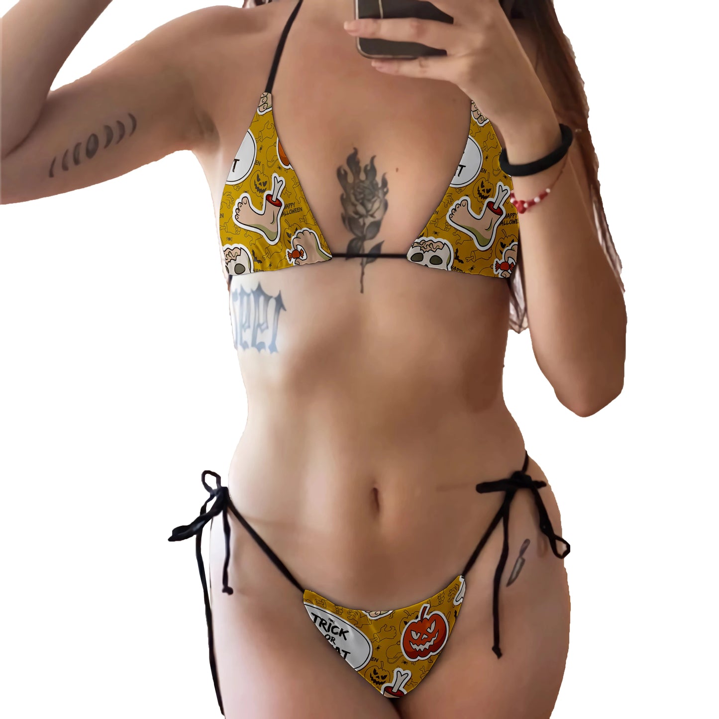 EtherealBe skull print bikini set on model with yellow Halloween skull pumpkin motifs tie side bikini