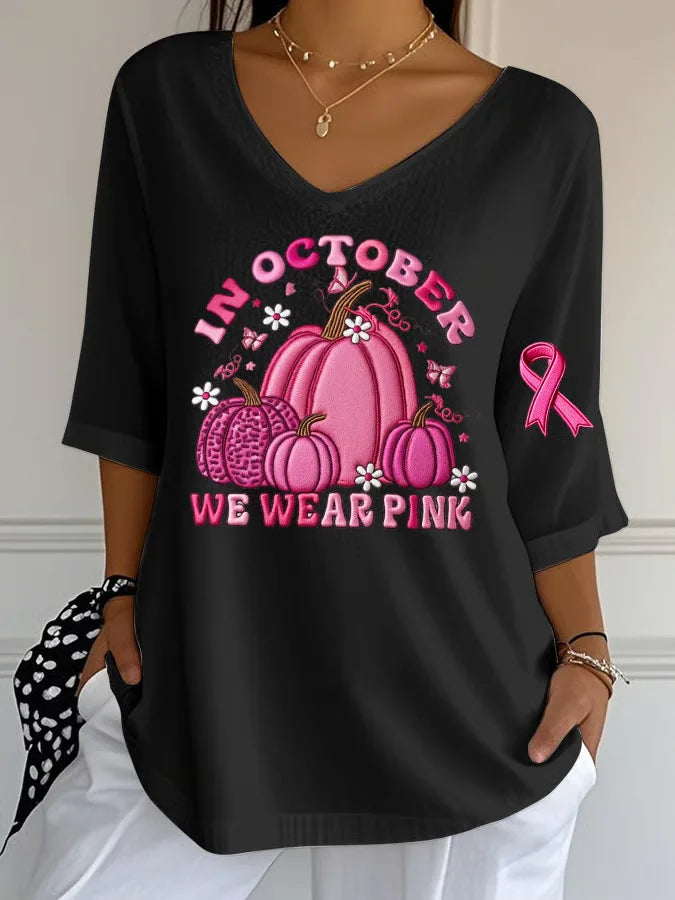 Women's Halloween graphic t-shirt featuring pink pumpkins and breast cancer awareness design