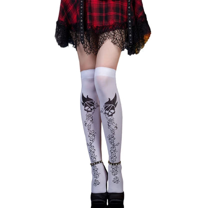 Feminine model wearing two-toned Halloween tights for women with skull and decorative designs