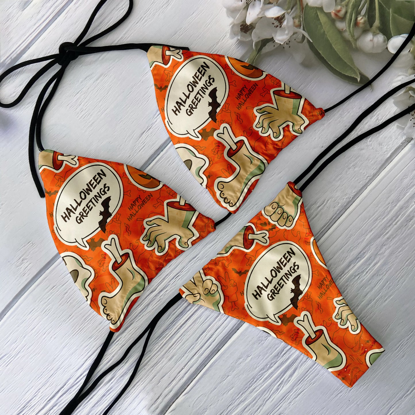 EtherealBe skull print bikini set orange Halloween Greetings graphic with zombie hands and bones