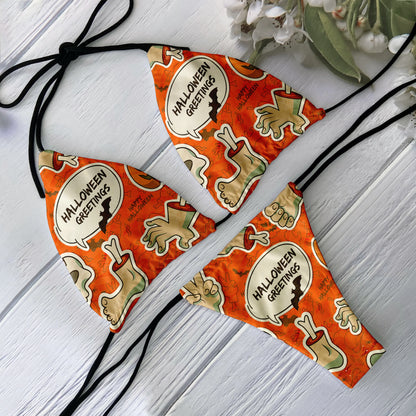EtherealBe skull print bikini set orange Halloween Greetings graphic with zombie hands and bones