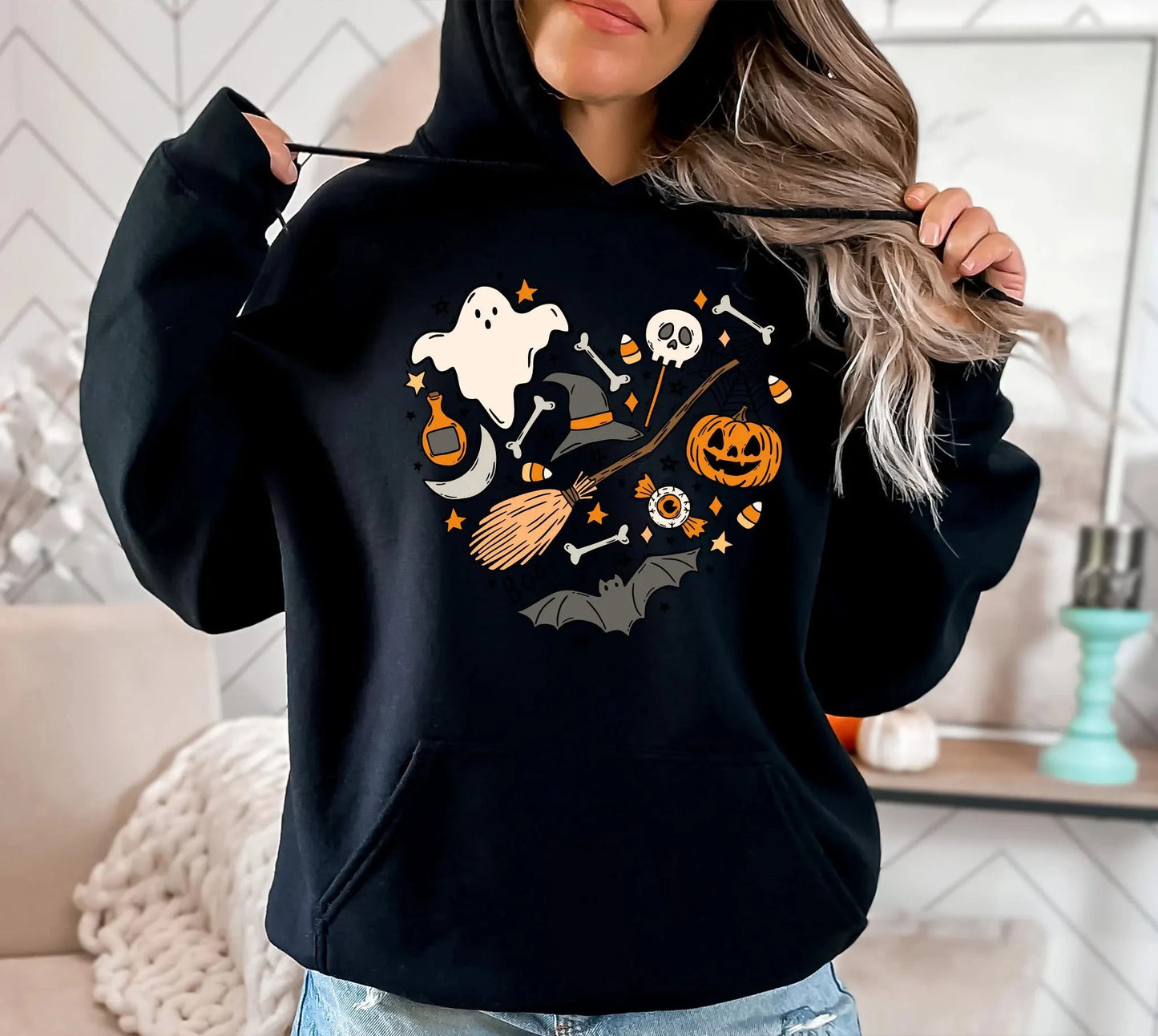 Black Halloween spooky hoodie for women featuring fun ghost and pumpkin graphics