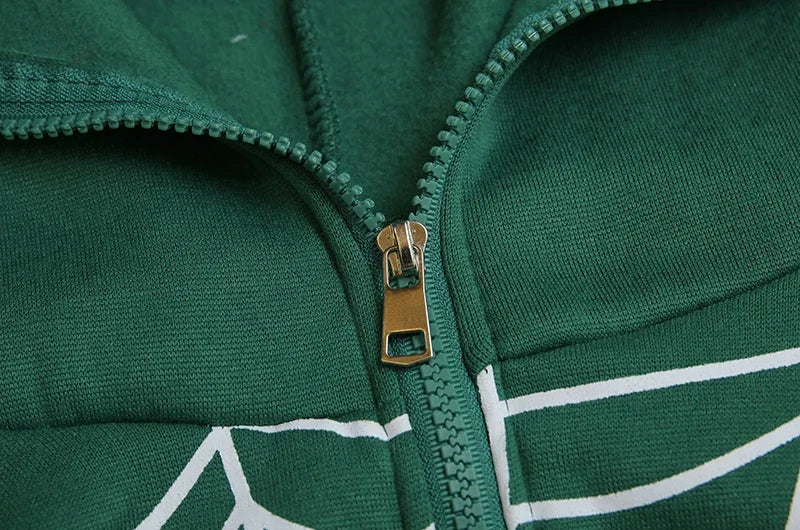 Close up of green cotton spider web zipper hoodie for women showing metal zipper and white web print