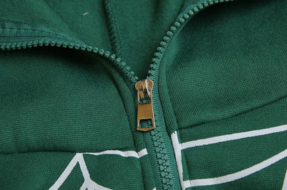 Close up of green cotton spider web zipper hoodie for women showing metal zipper and white web print
