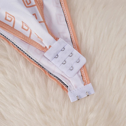 Close up of hook and eye closure on peach trimmed kawaii cartoon bodysuit costume for women lying on faux fur