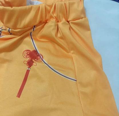 Zoey Rumi kids costume orange satin skirt with elastic waist and red tassel knot print detail