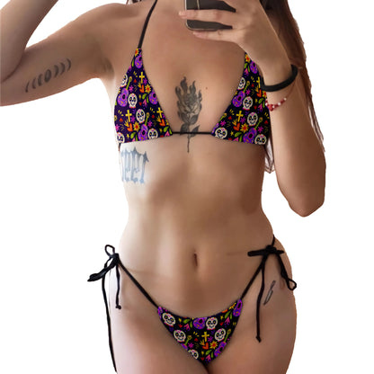 Woman wearing EtherealBe skull print bikini set with colorful Day of the Dead skulls and black tie strings