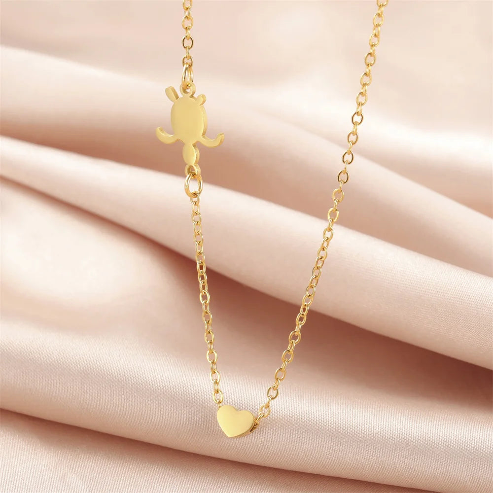 EtherealBe sea turtle pendant necklace for women featuring a gold design on a soft fabric background