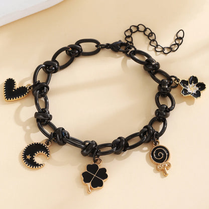 EtherealBe Halloween charm bracelet for women featuring black charms and gold accents