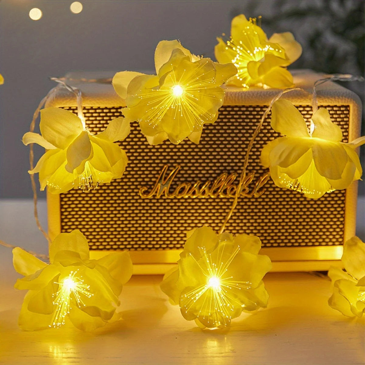 EtherealBe fairy flower string lights with yellow blooms illuminating a vintage speaker