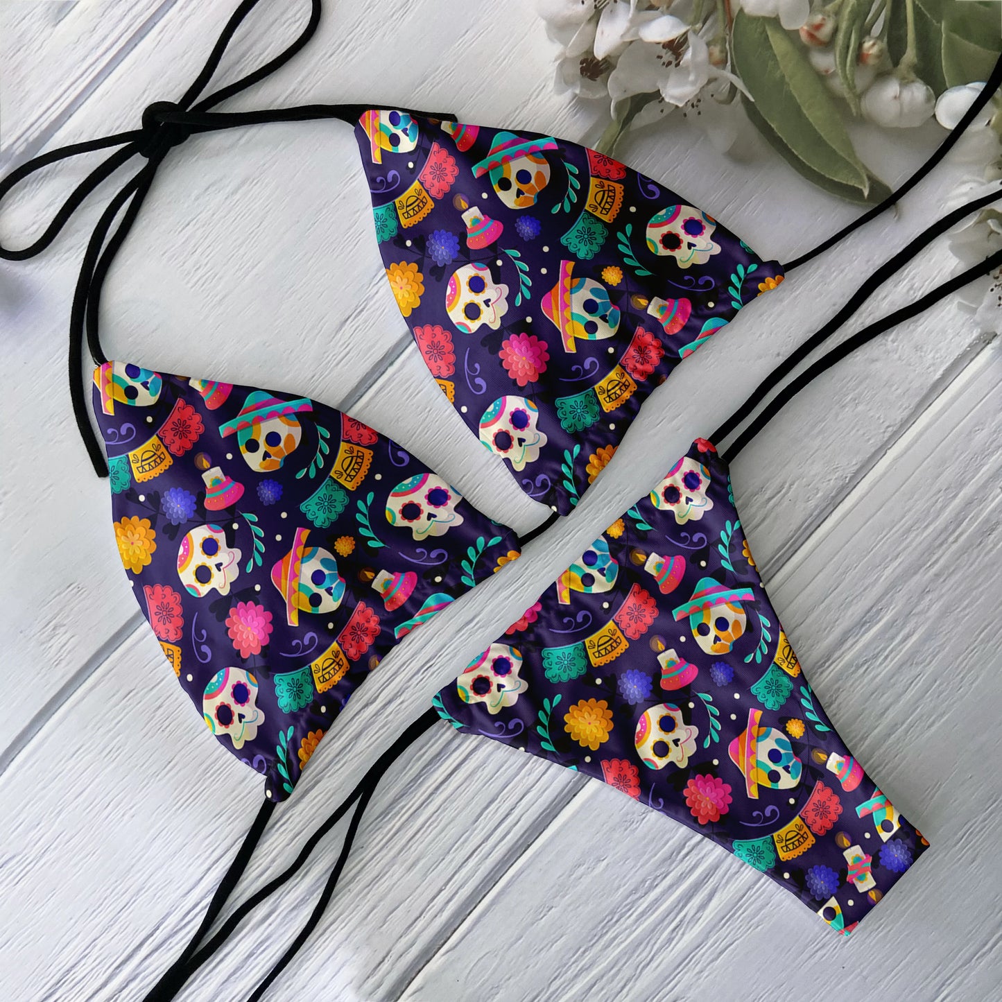 EtherealBe skull print bikini set with colorful Day of the Dead skulls on purple triangle top and tie bottoms