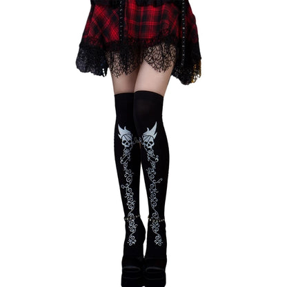 Two-toned Halloween tights for women featuring skull designs and intricate patterns for a spooky look
