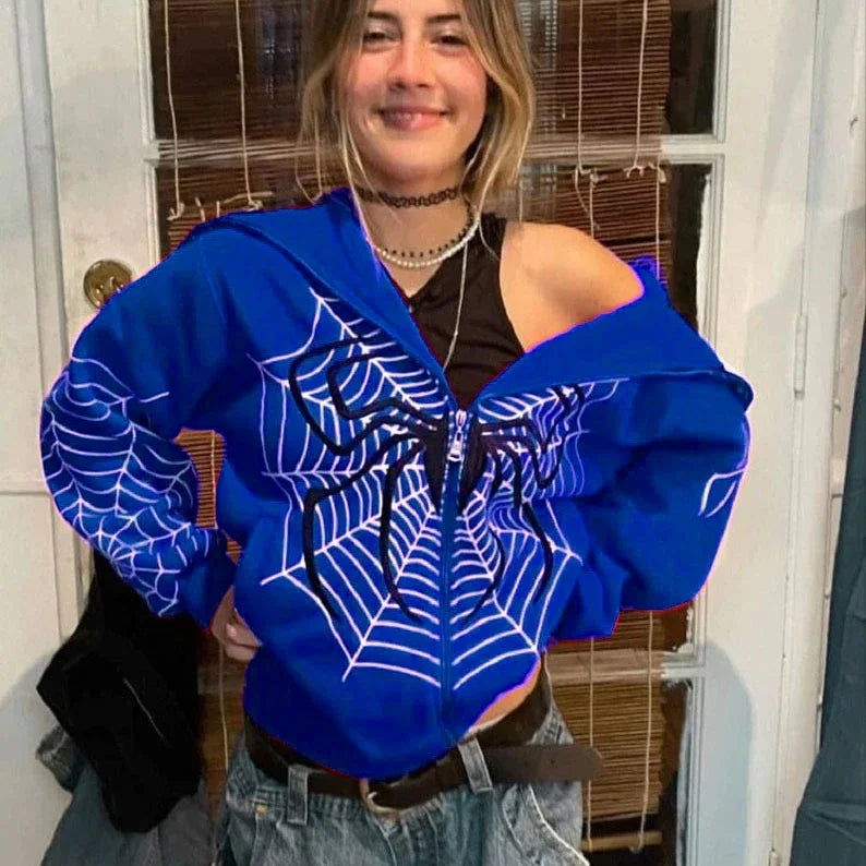 Blue spider web zipper hoodie for women styled off shoulder on smiling model with black tank and jeans