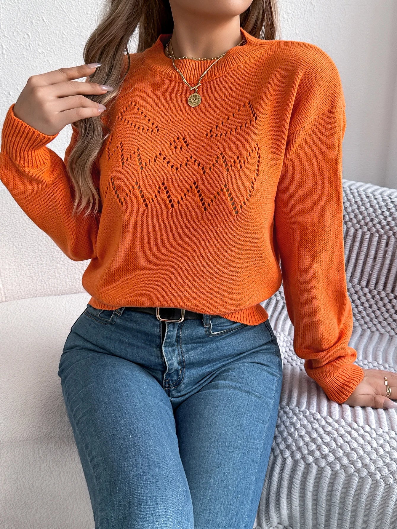Women's pumpkin sweater in vibrant orange with cute pumpkin face design for autumn fashion