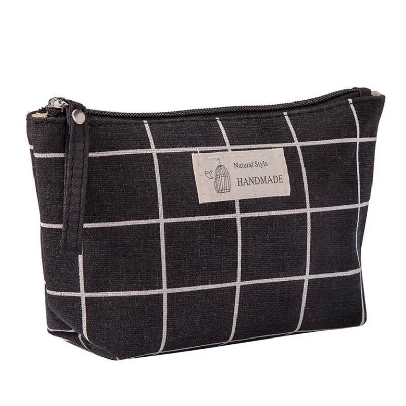 Black and white checkered travel makeup bag for women with a zipper closure and handcrafted design