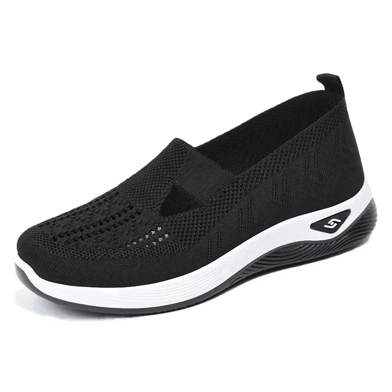 Black lightweight women's walking flats with breathable mesh design and slip-on style for comfort