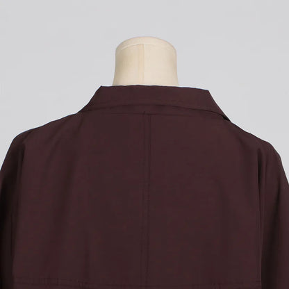 Back view of a simple style long sleeve trench coat in dark burgundy color