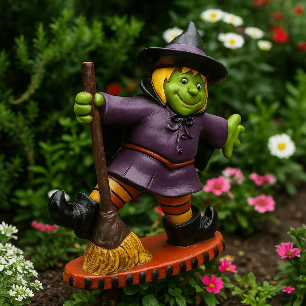 EtherealBe Halloween witch figurine with a green face, purple outfit, and broomstick surrounded by colorful flowers