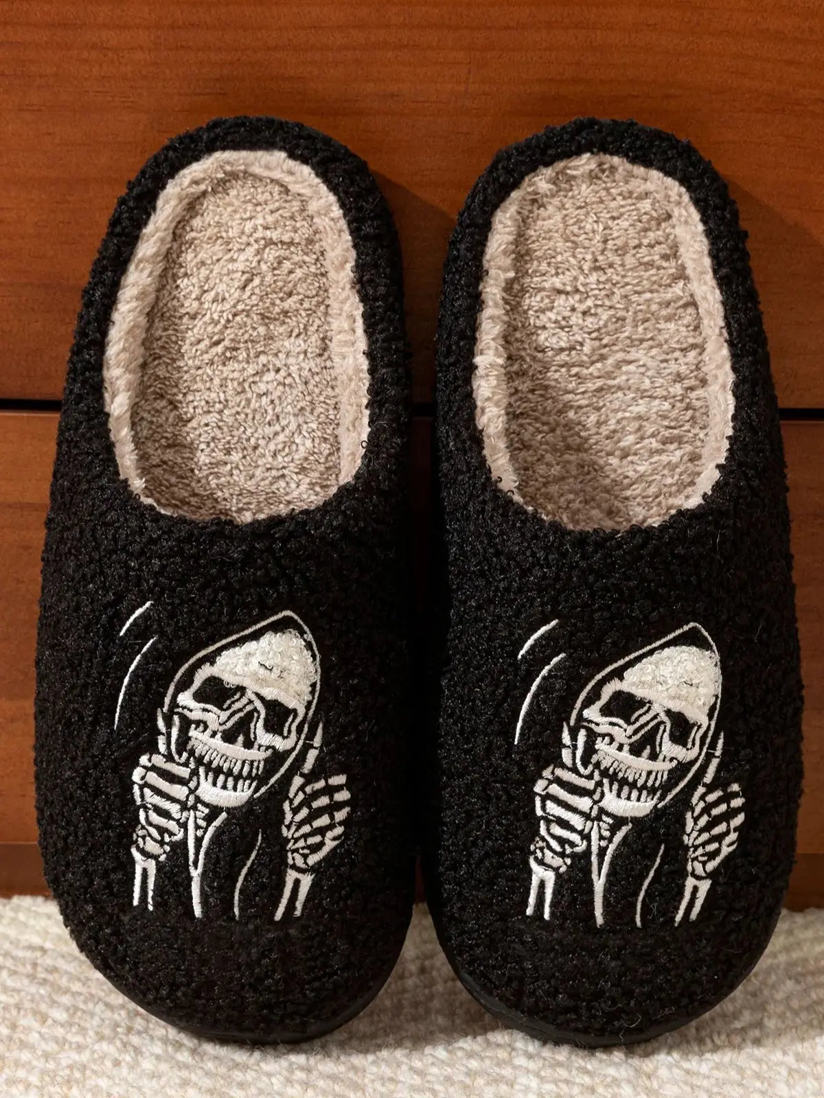 Black women’s slippers with a skull face design and soft lining for cozy comfort