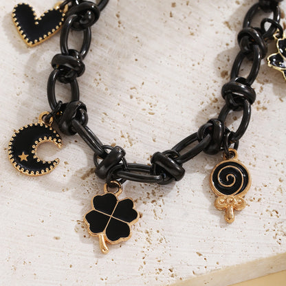 EtherealBe Halloween charm bracelet for women featuring black and gold charms and candy designs
