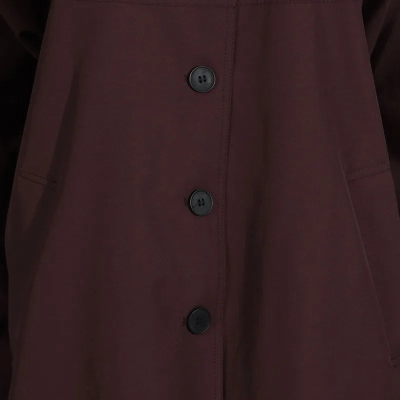 Simple style long sleeve trench coat in deep maroon with button closure and front pockets