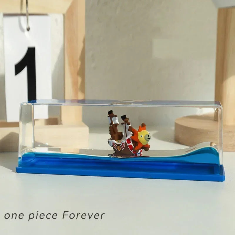 Mini One Piece Thousand Sunny drift bottle decorative toy inside clear acrylic display case on blue base