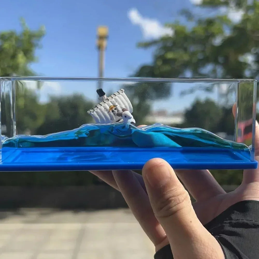 Handheld One Piece Thousand Sunny drift bottle decorative toy diorama in clear display case showing ship on blue waves