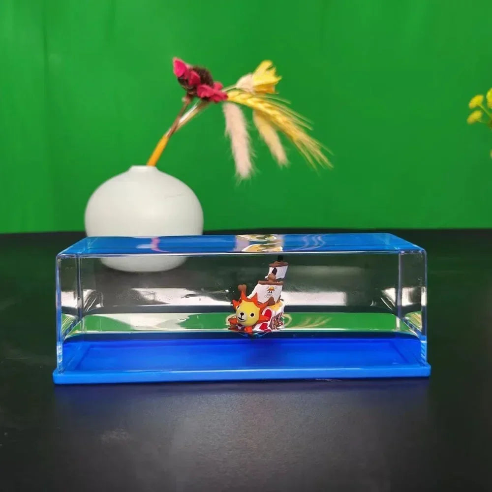 One Piece Thousand Sunny drift bottle decorative toy displayed in clear rectangular acrylic case with blue base