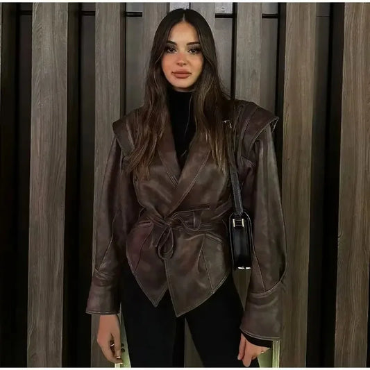 Model wearing EtherealBe half collar faux leather jacket in dark brown wrap style with belt and structured shoulders