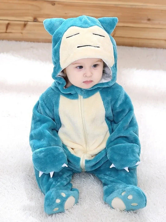 Infant sitting in teal plush snorlax baby cosplay bodysuit costume with hooded Snorlax face paw feet and front zipper