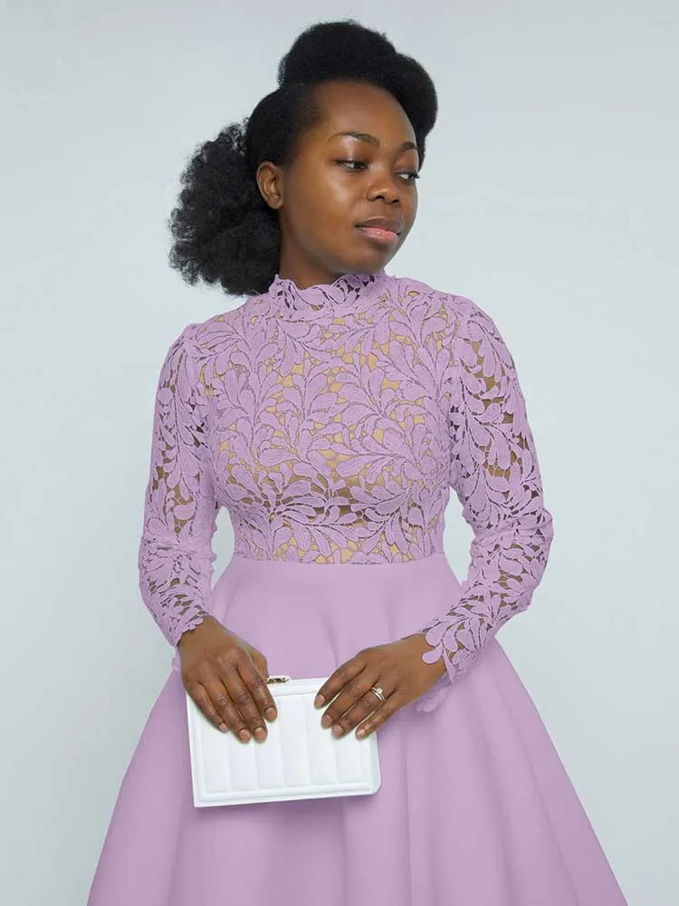 Woman in lilac elegant lace party dress for women with high neck long sleeves holding white clutch